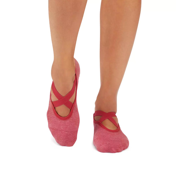 Tavi grip socks in Ruby Heather, shown on feet with open tops and contrasting crossover straps.